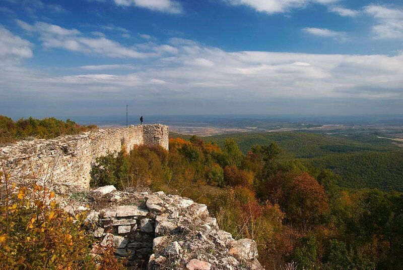 Ancient ruins overlook autumn hills