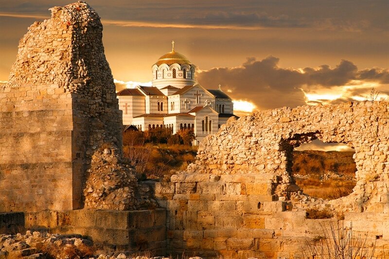 Ancient ruins with church at sunset
