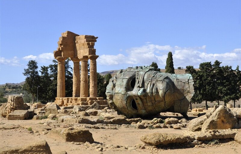 Ancient ruins with giant head sculpture