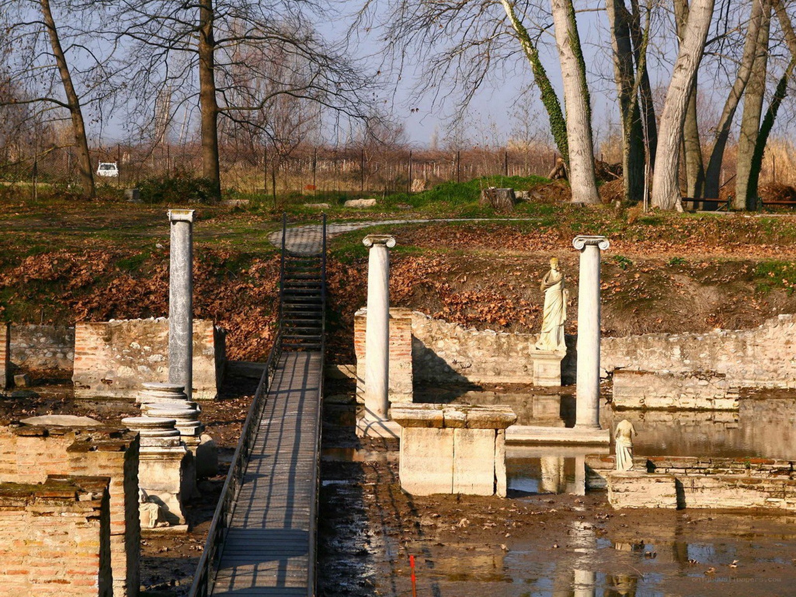 Ancient ruins with statues and columns
