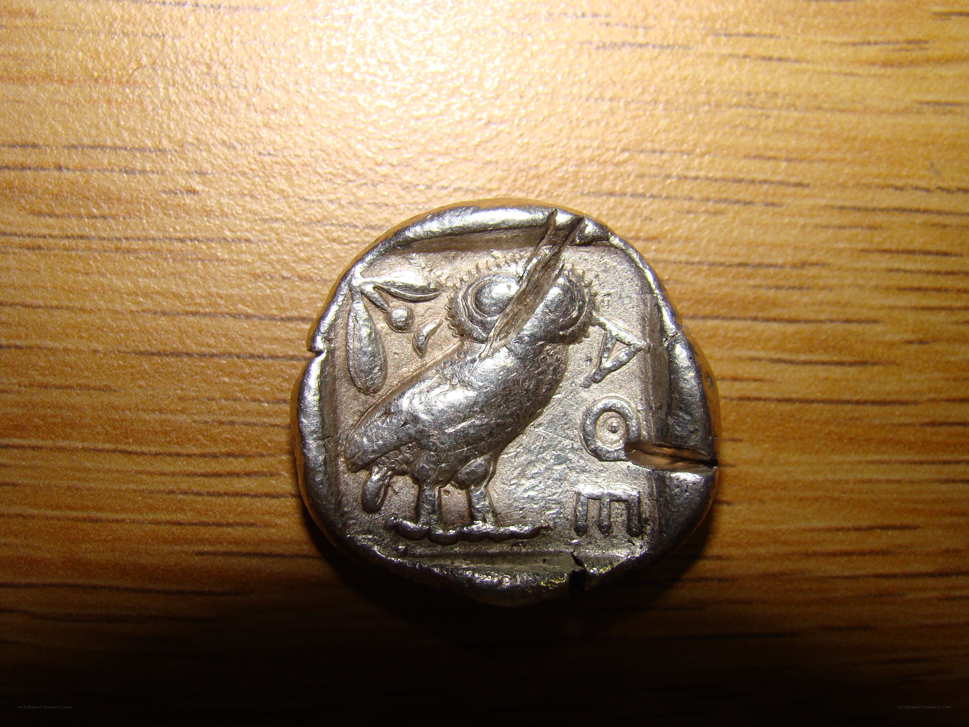 ancient silver coin with owl