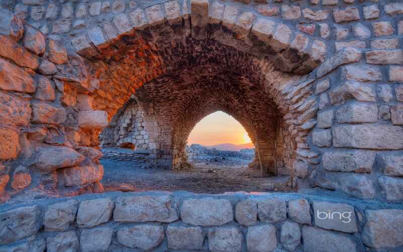 Ancient stone arch at sunset