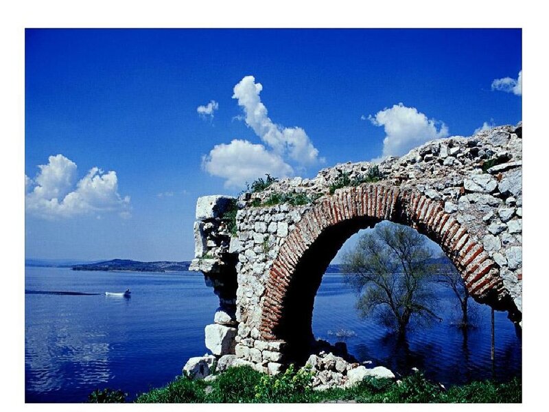 Ancient stone arch by the lake