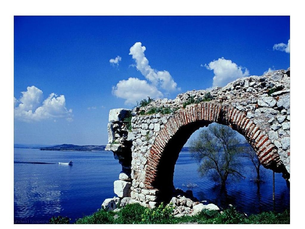 Ancient stone arch by the lake
