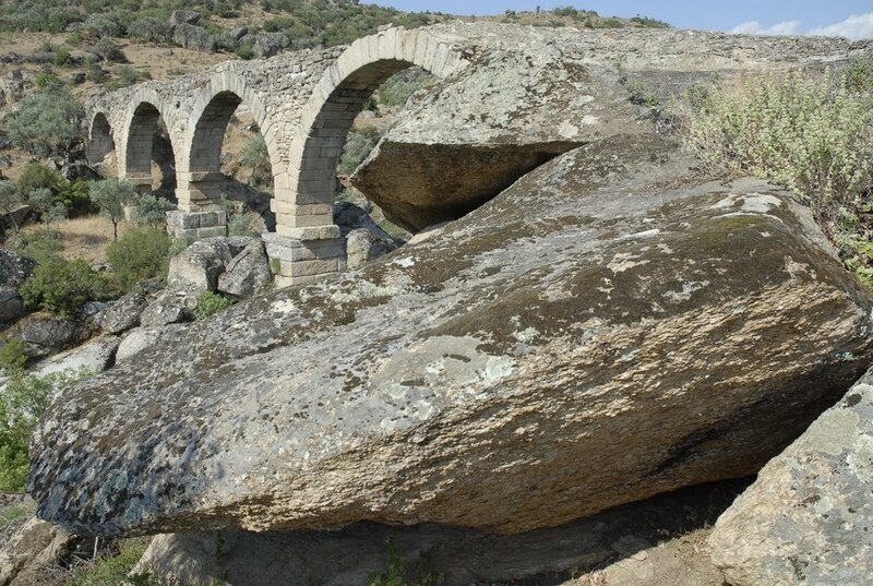 Ancient stone bridge in a rocky landscape