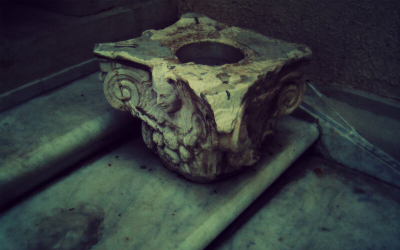 ancient stone capital on steps