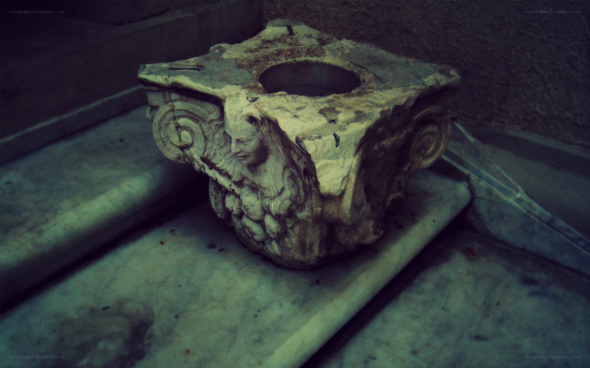 ancient stone capital on steps