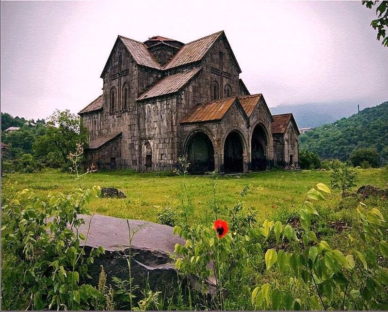 ancient stone church in a green field