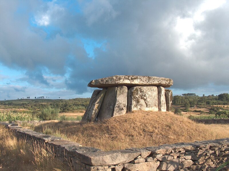 Ancient stone dolmen under cloudy sky
