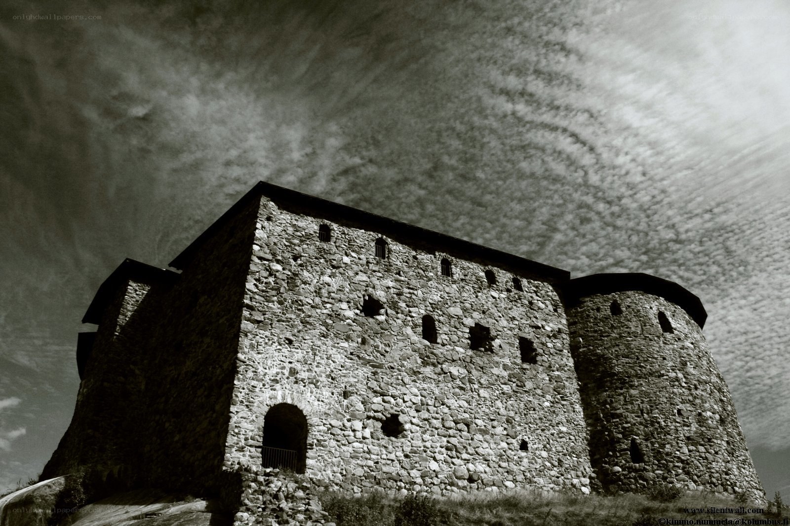 Ancient stone fortress under cloudy sky