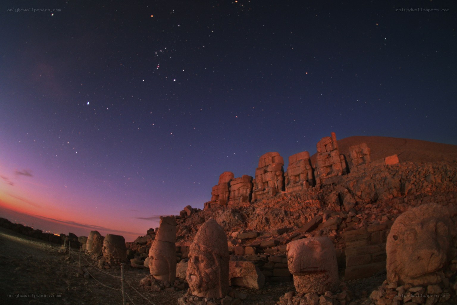 Ancient stone heads under starry sky