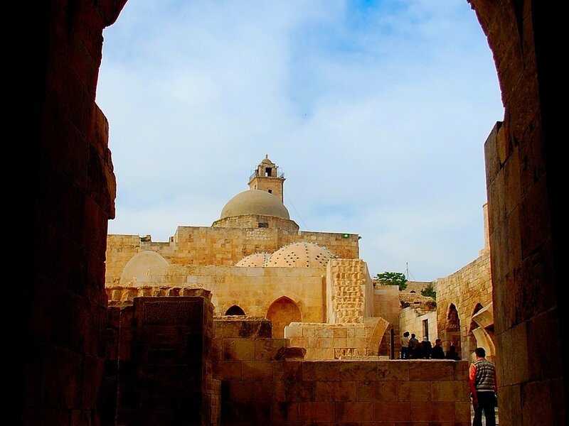 ancient stone mosque through archway
