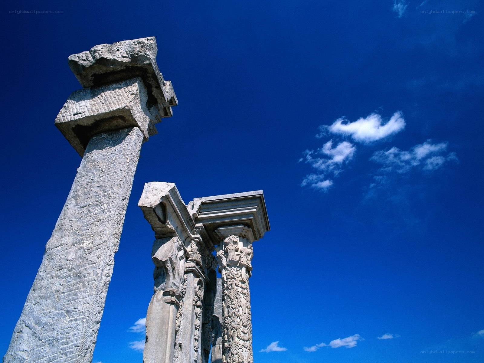 ancient stone pillars under blue sky