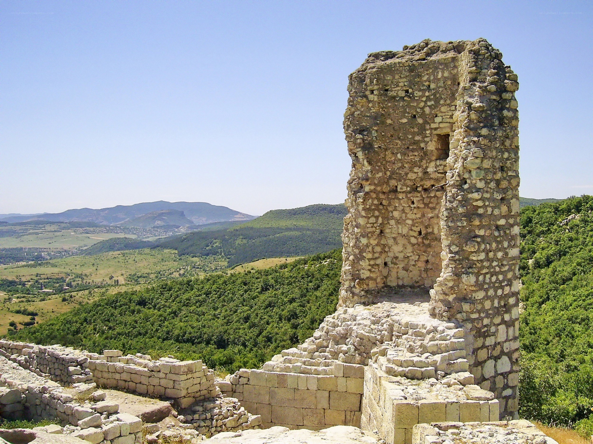 Ancient stone ruins overlook valley