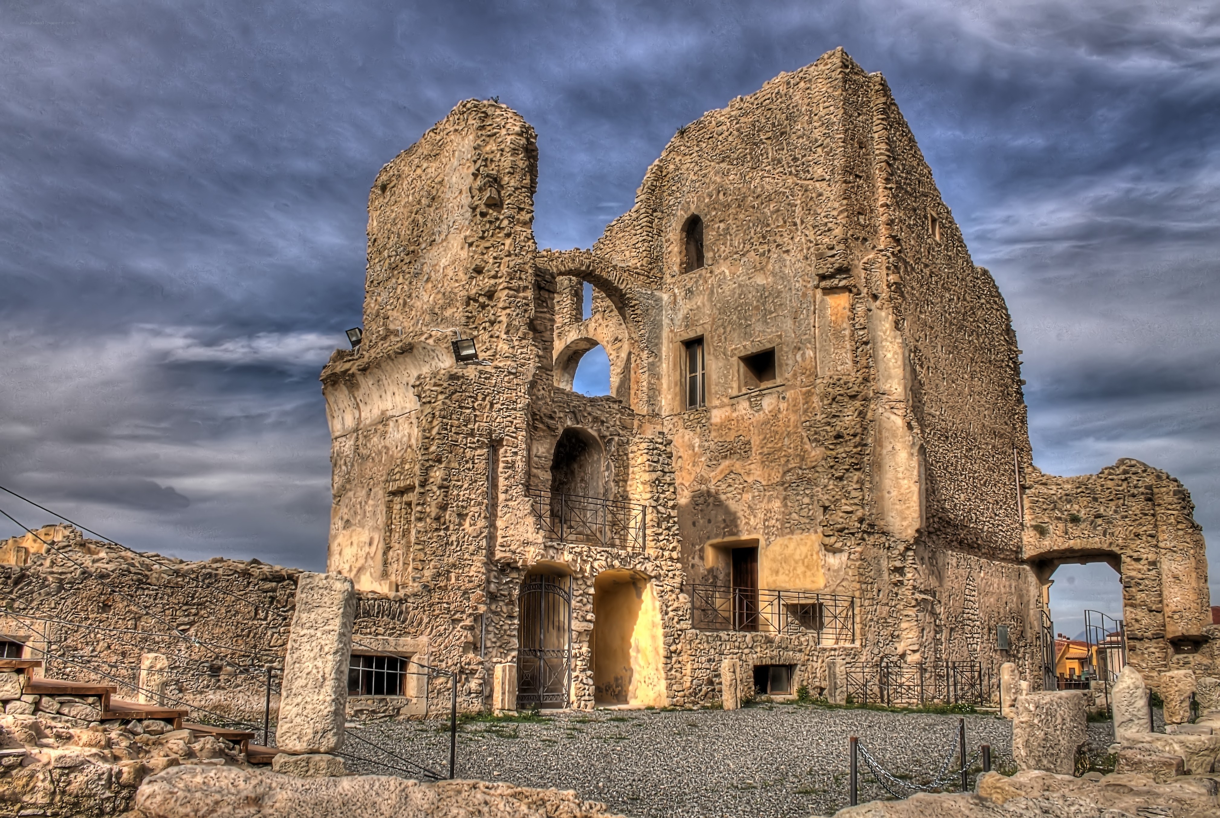 ancient stone ruins under cloudy sky