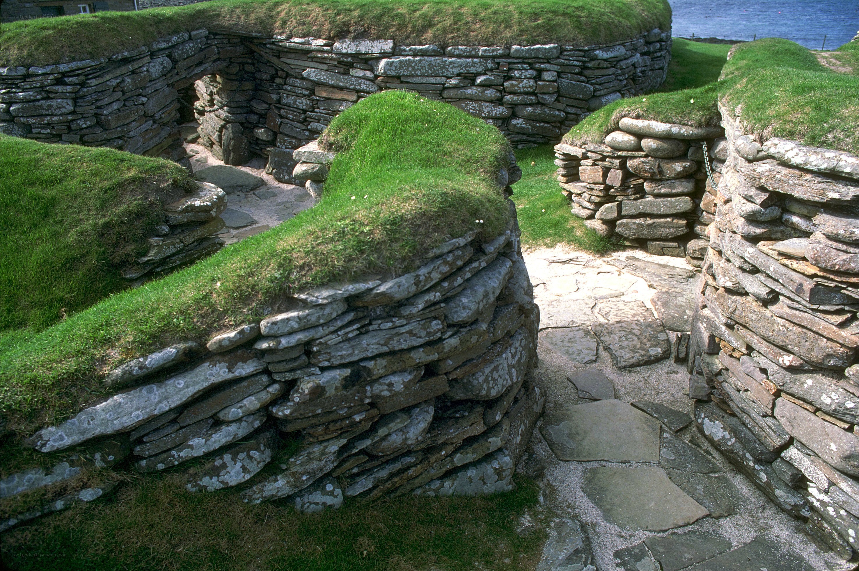 ancient stone structures with grass roofs