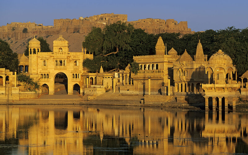 ancient temple by lake at sunset