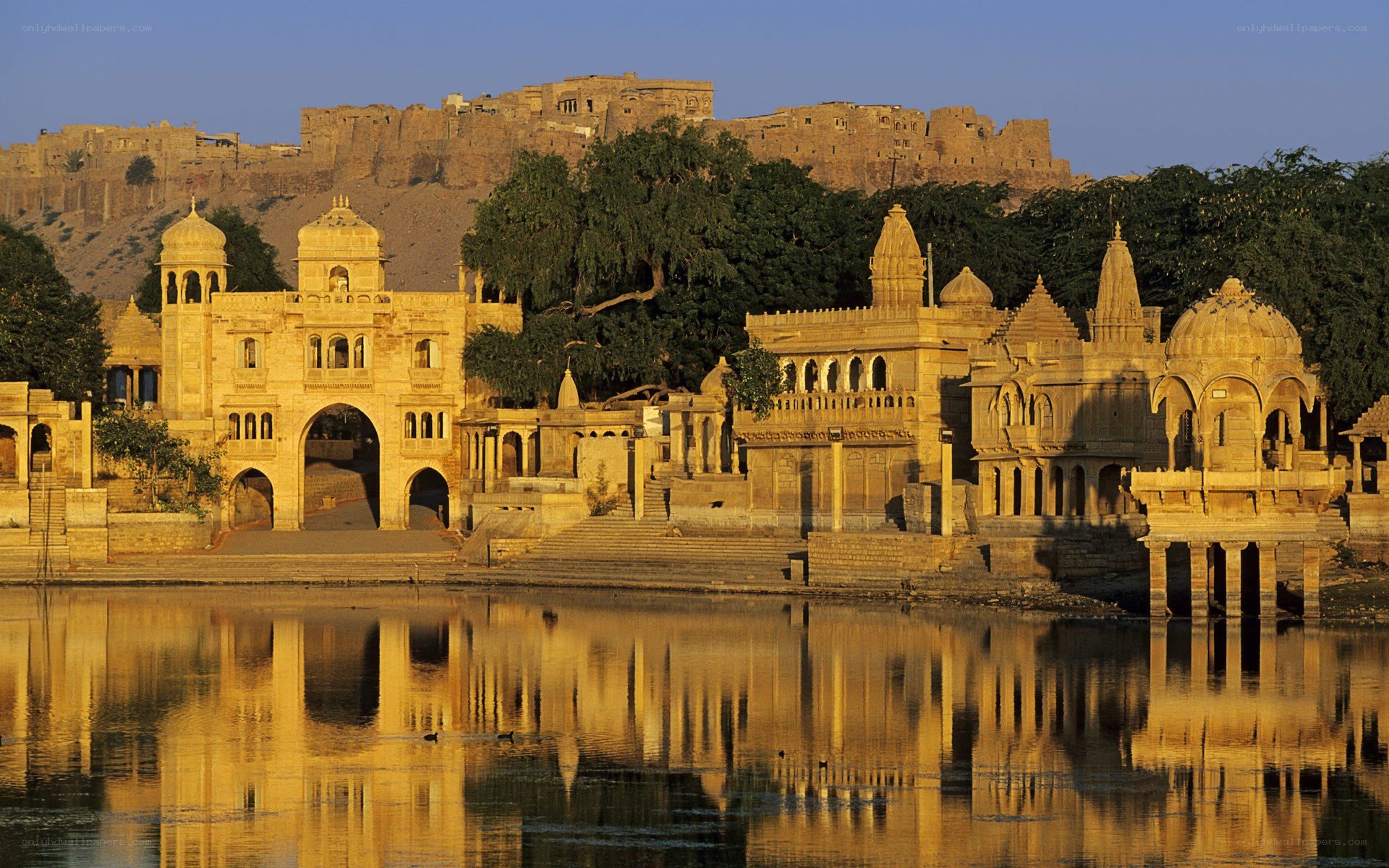 ancient temple by lake at sunset