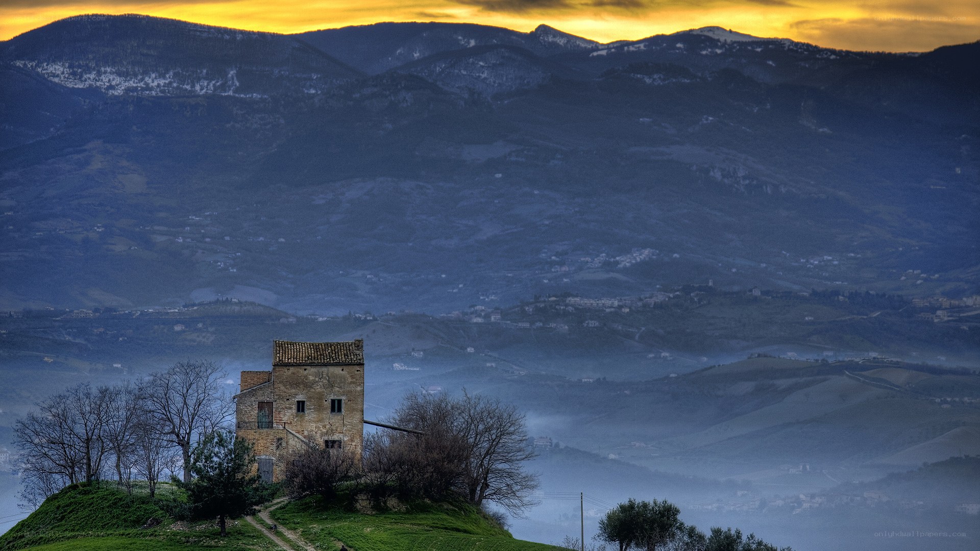 Ancient tower on a hill at sunset