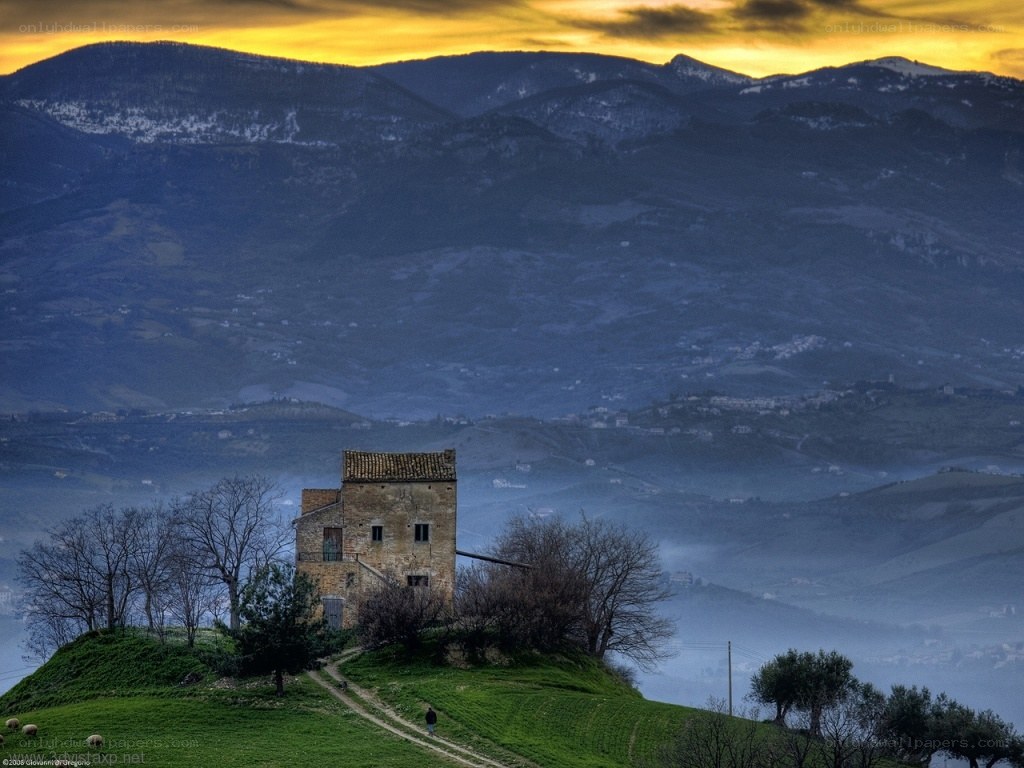 Ancient tower on a hill at sunset