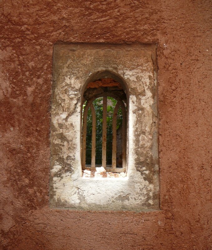 ancient window in a stone wall