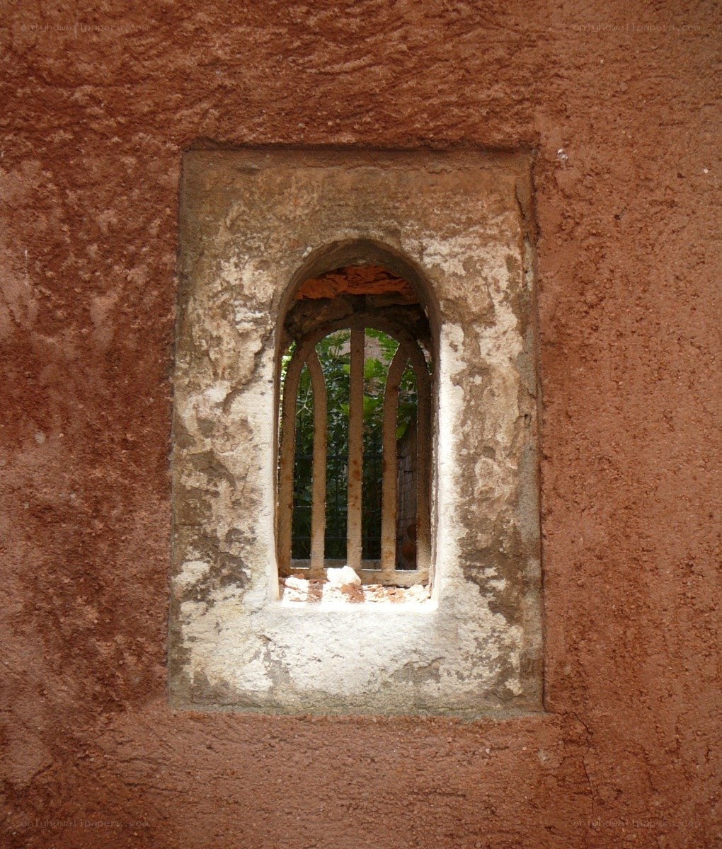 ancient window in a stone wall