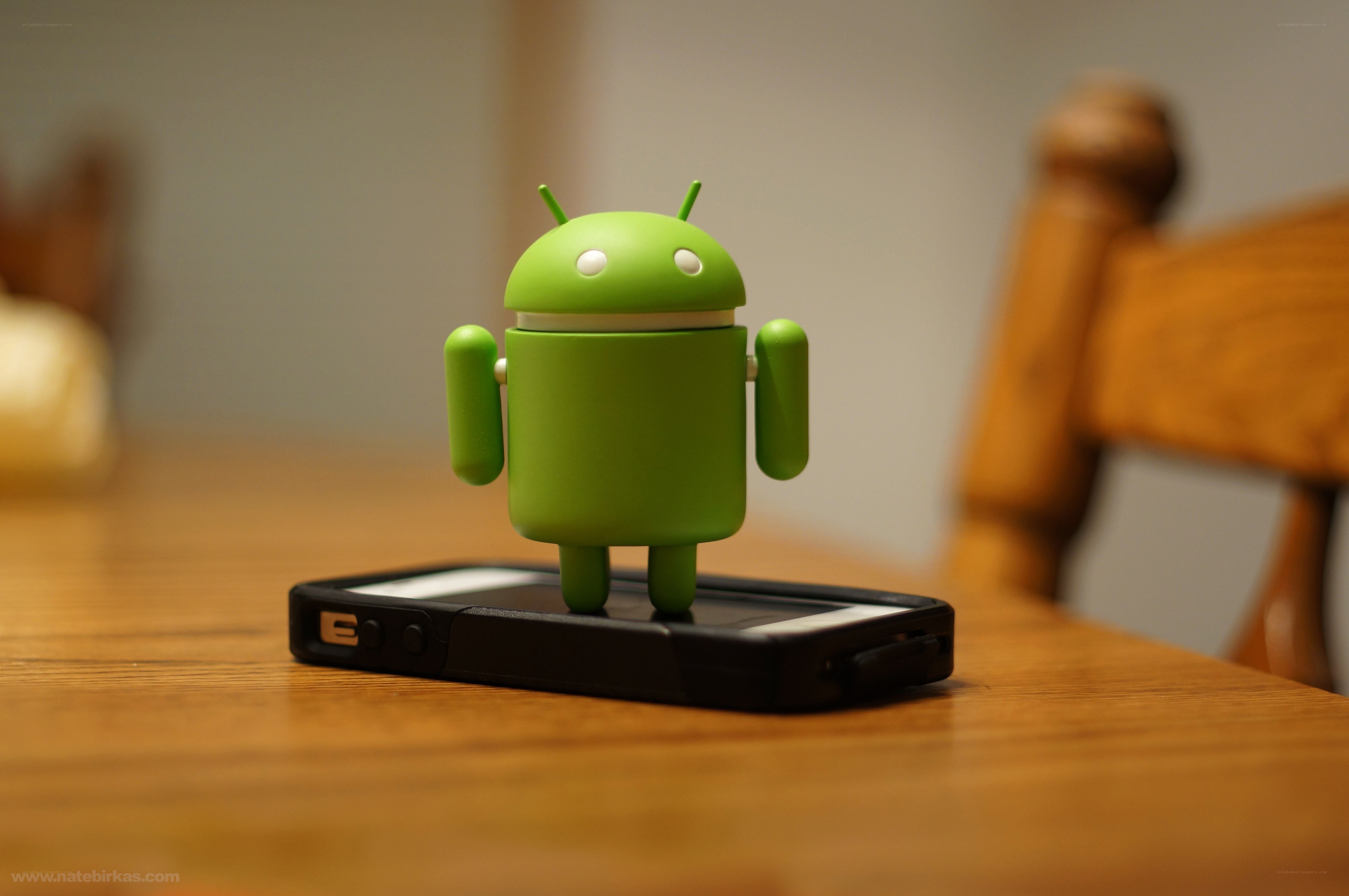 Android figurine on phone