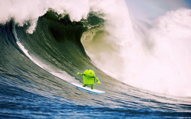Android surfing a wave
