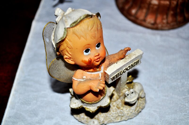 Angel figurine holding welcome sign