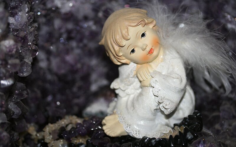 Angel figurine with amethyst crystals