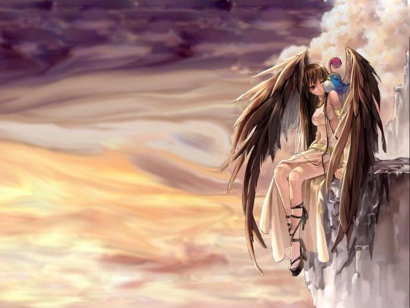 angel on a cliff at sunset