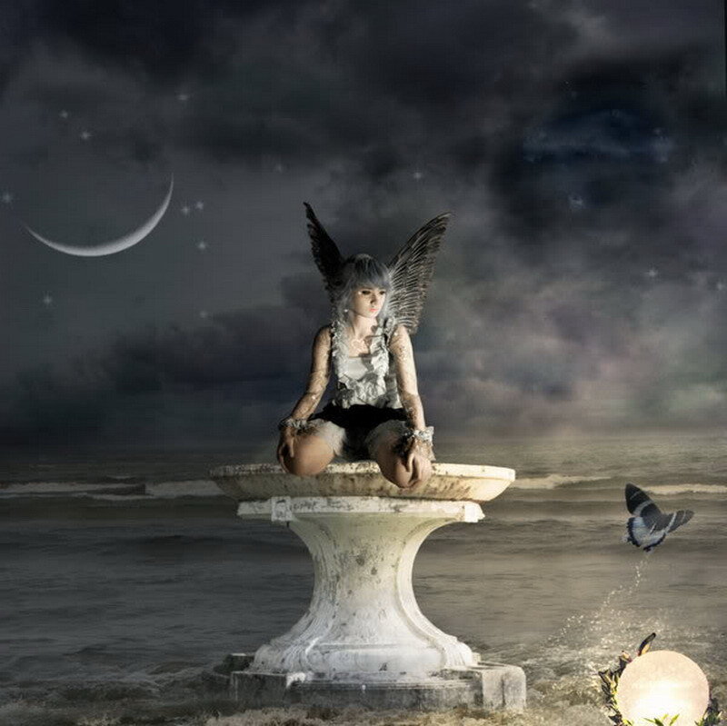 angel on a pedestal at night