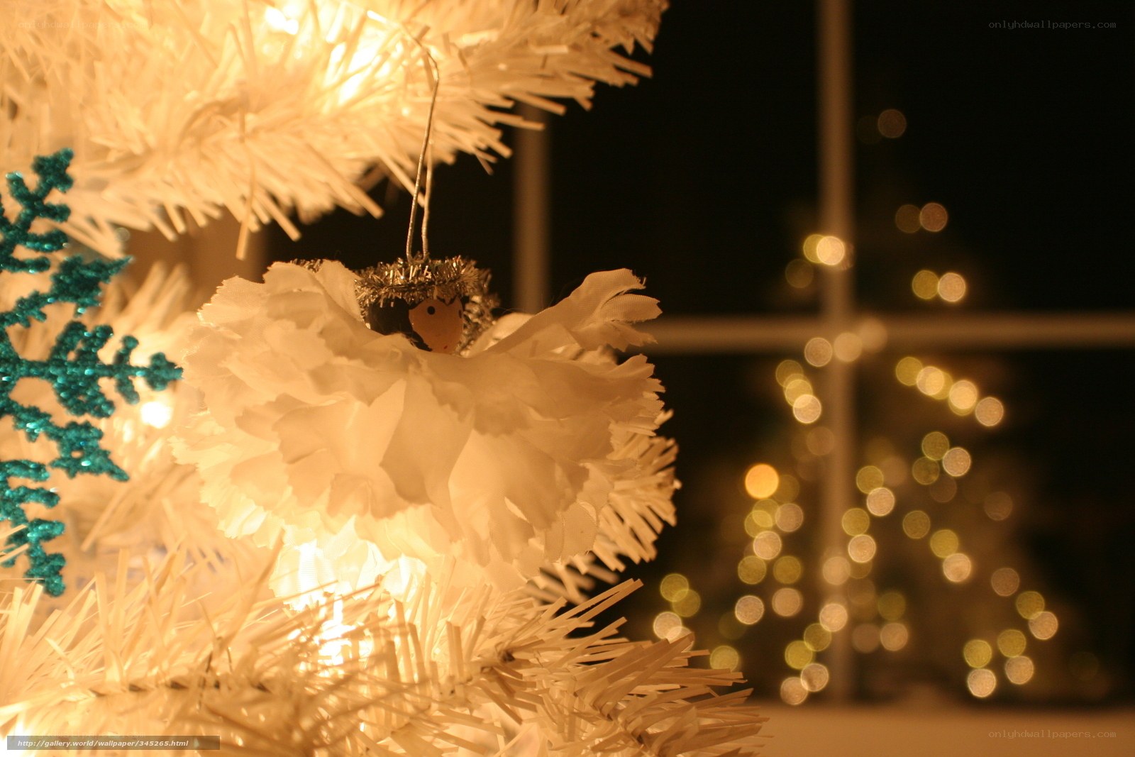 Angel ornament on white tree