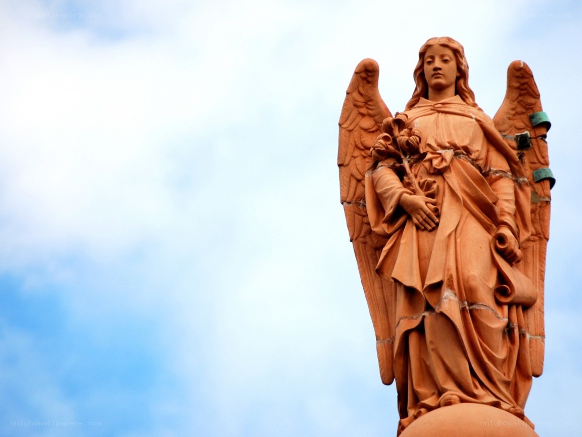Angel statue against blue sky