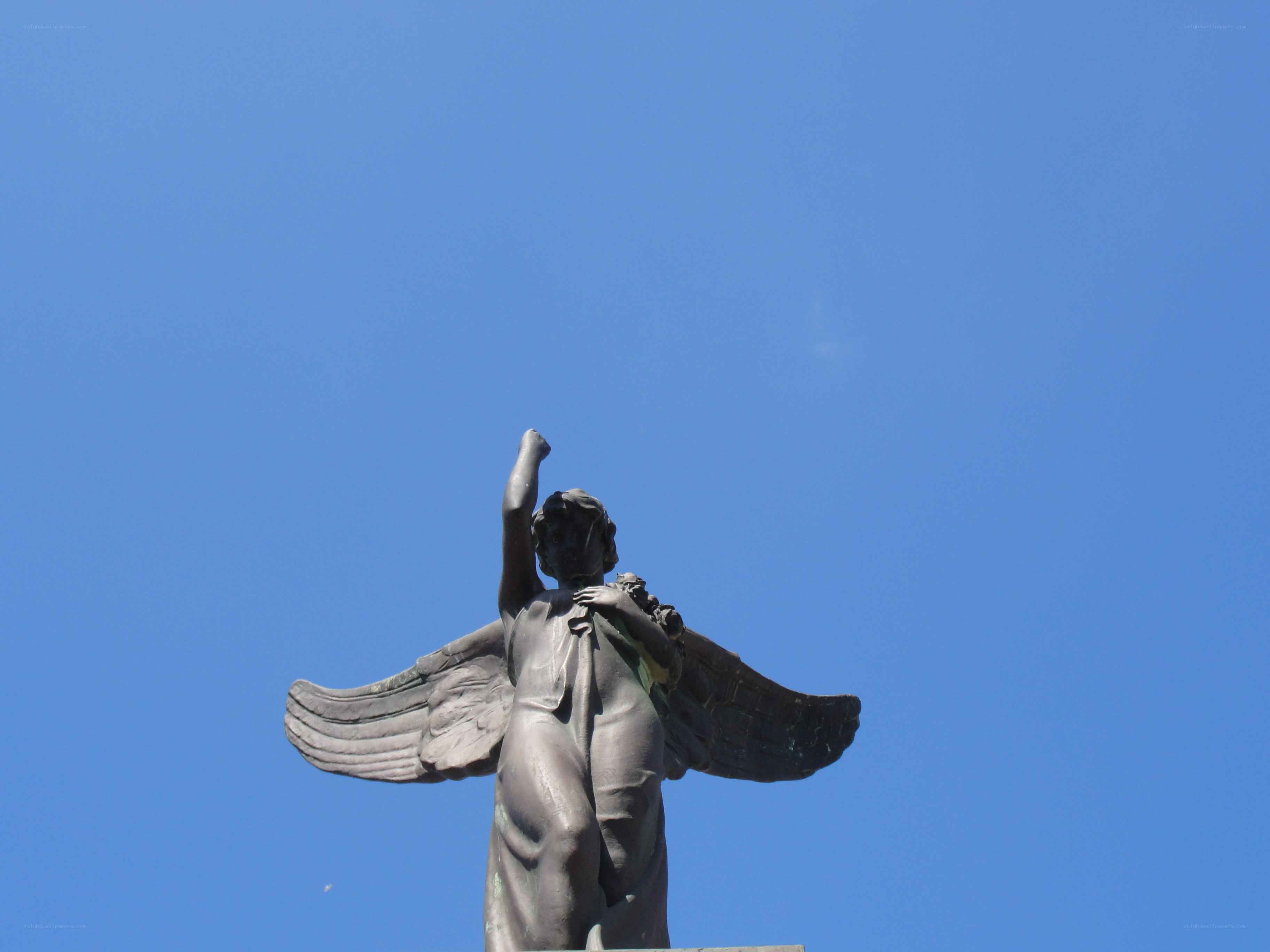 Angel statue against blue sky