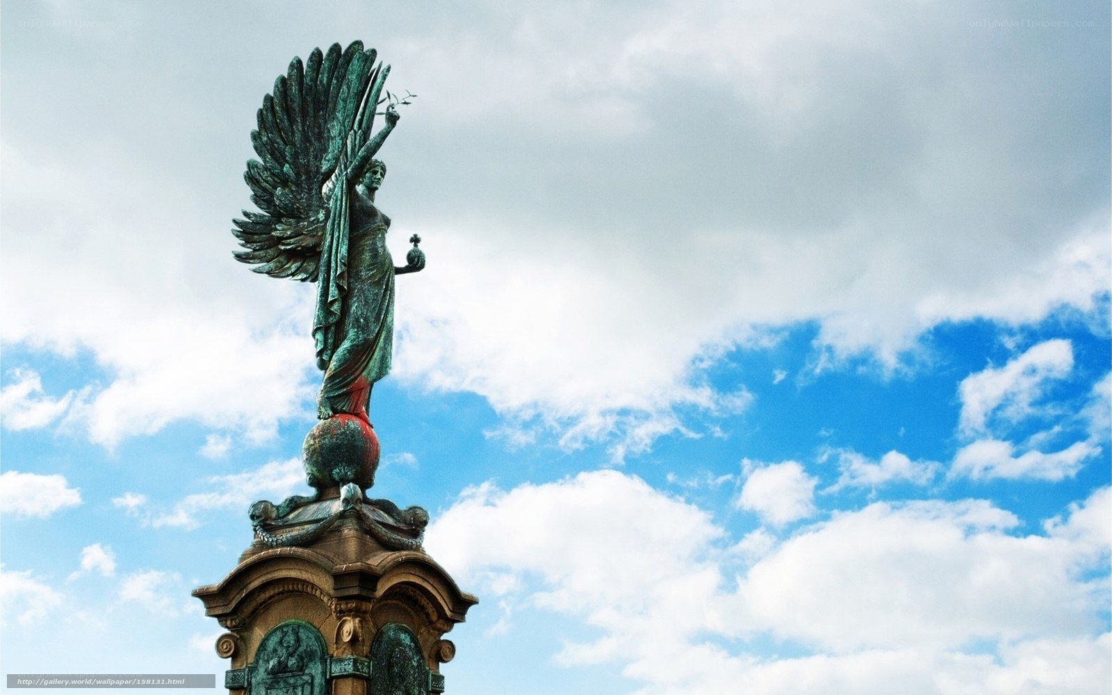 Angel statue against blue sky