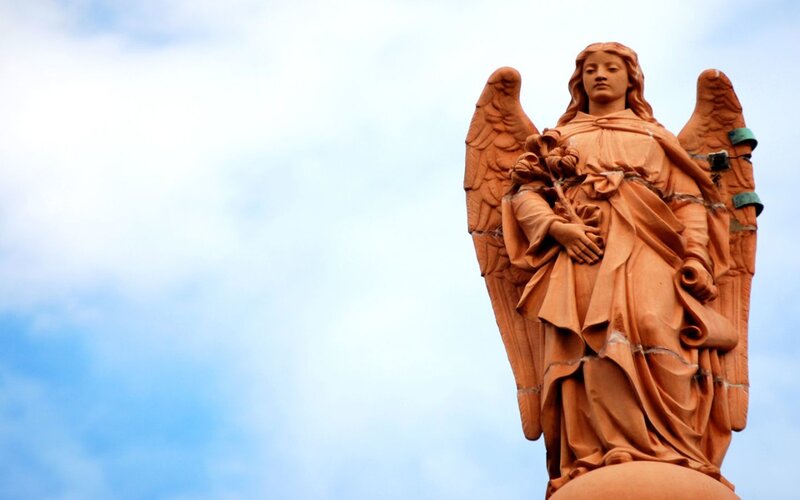 Angel statue against sky