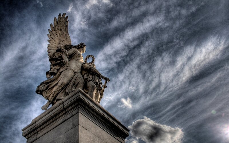 Angel statue against stormy sky