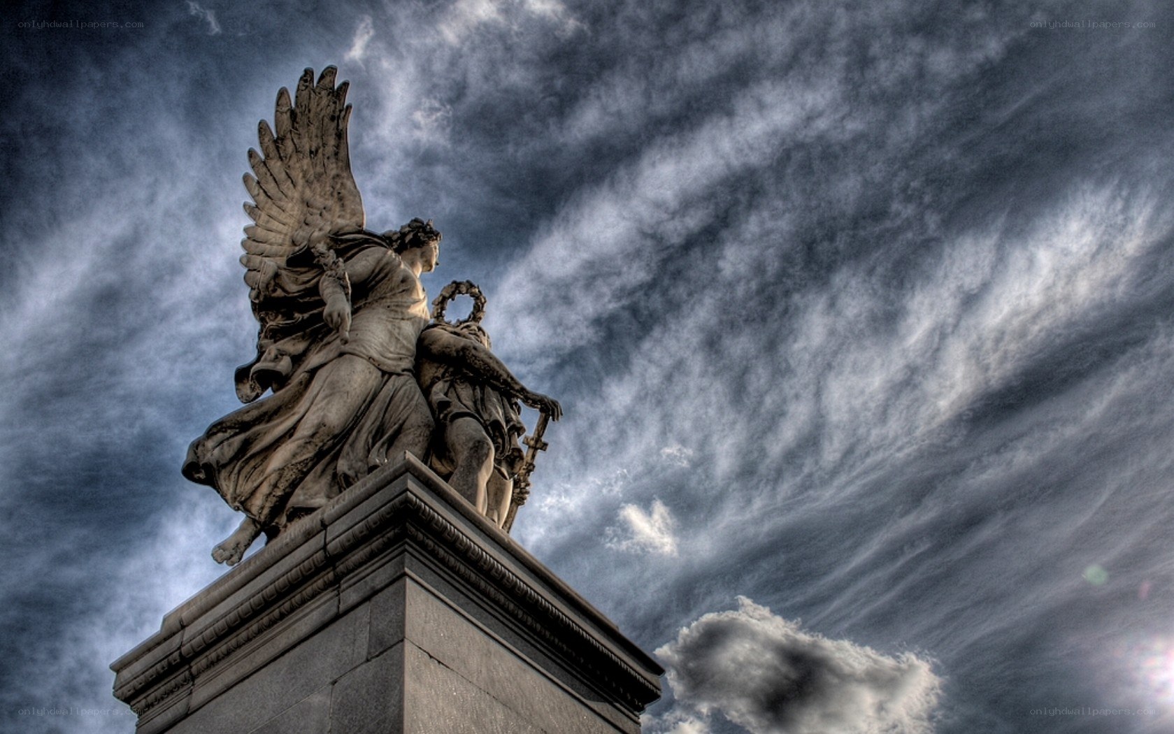Angel statue against stormy sky