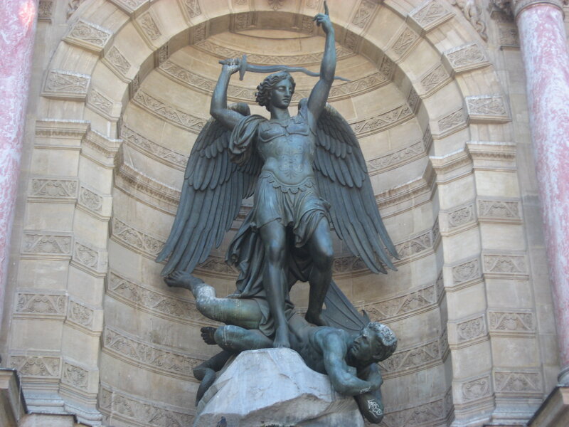 Angel statue defeating a demon