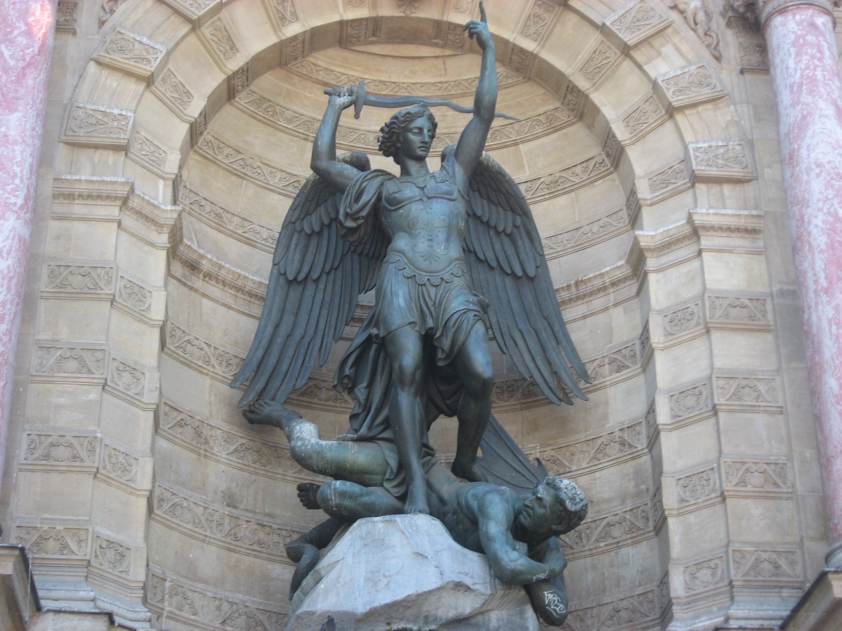 Angel statue defeating a demon