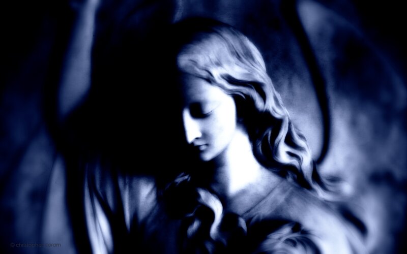 angel statue in blue light