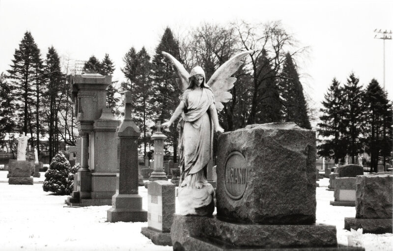 Angel statue in snowy cemetery