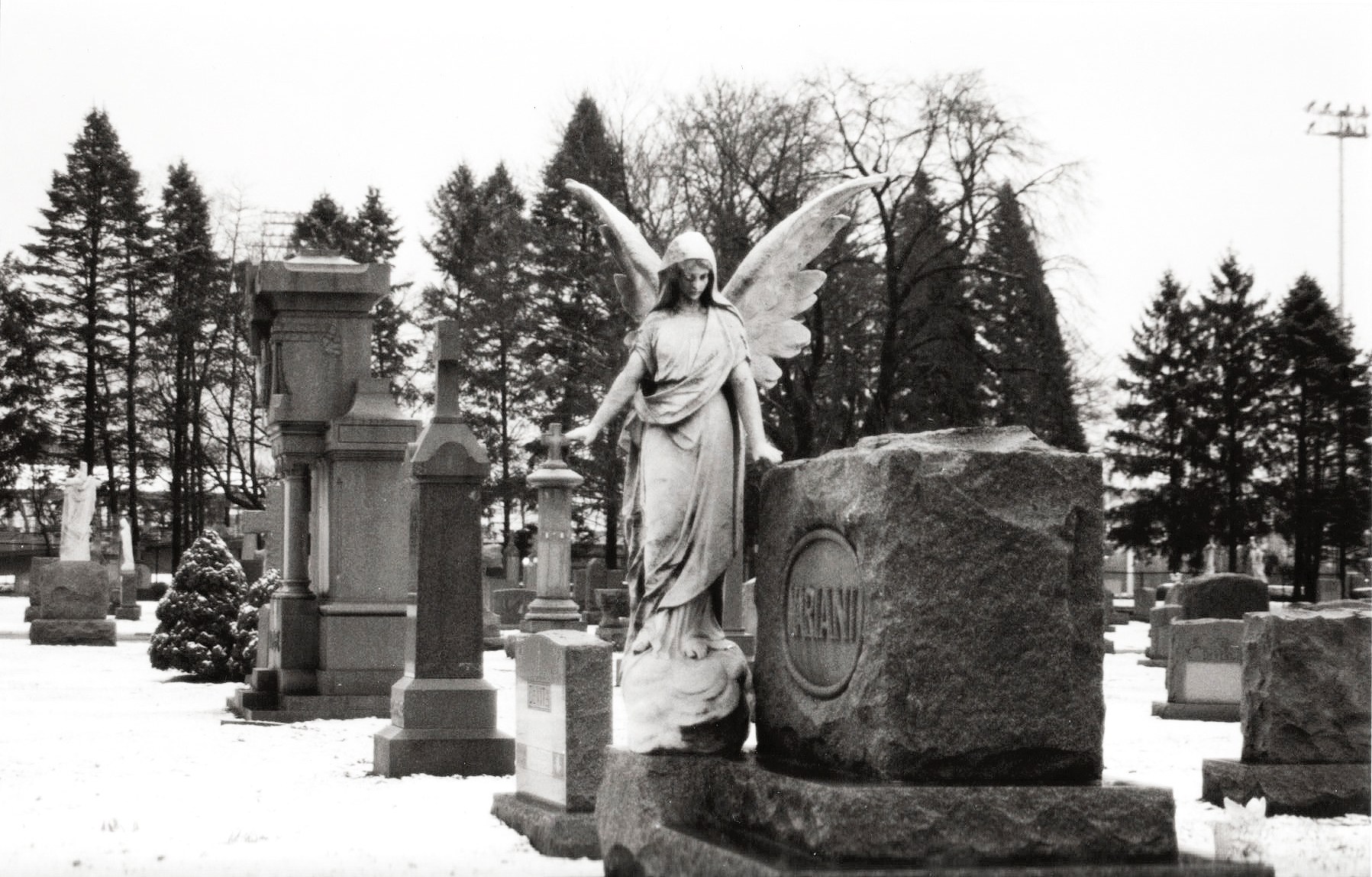 Angel statue in snowy cemetery