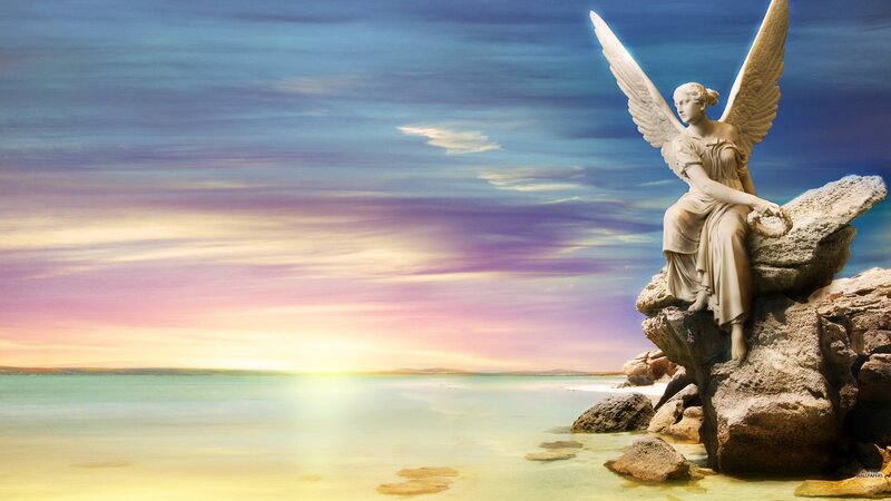 Angel statue on rocky shore