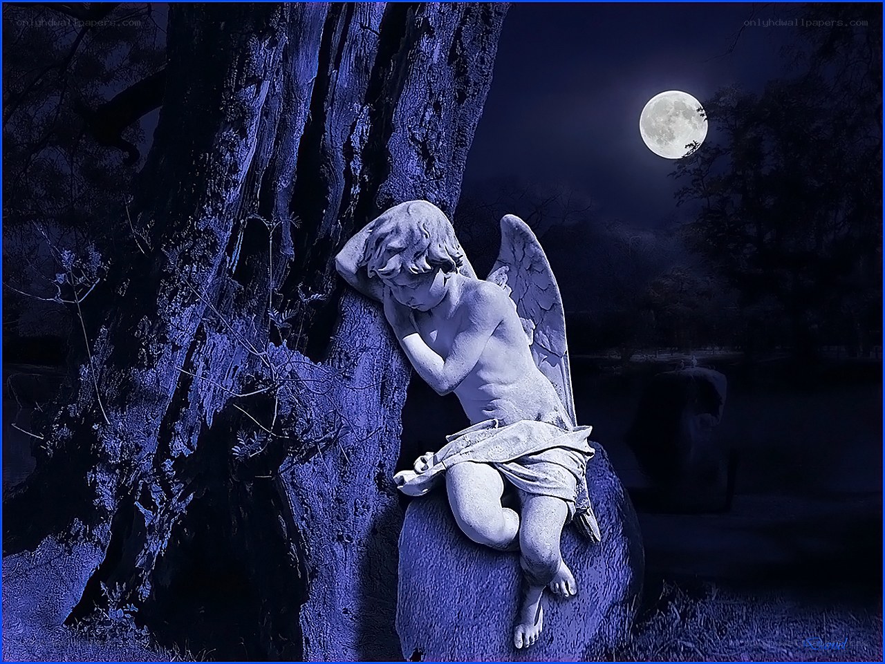 Angel statue under moonlight
