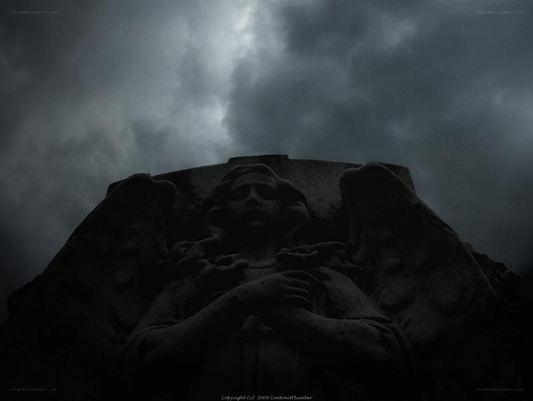 angel statue under stormy sky