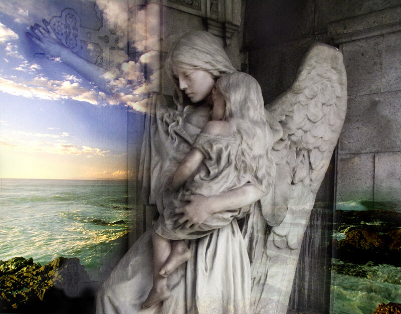 Angel statue with child by the sea