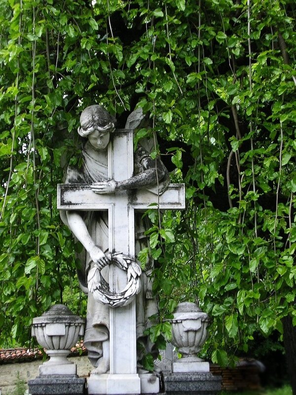 Angel statue with cross in garden