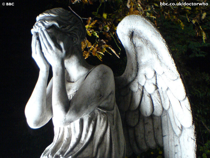 angel statue with hands covering face